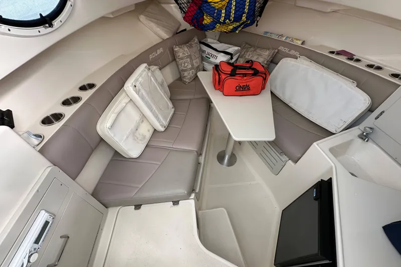 Slide: The Image of 2007 Polar 2300 Walkaround cabin interior with seating, table, and safety equipment. - 9