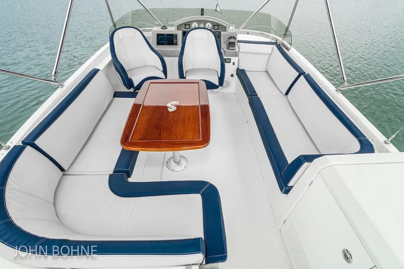Slide: The Image of 2018 Beneteau Swift Trawler 44 interior with elegant seating and wooden table. - 22