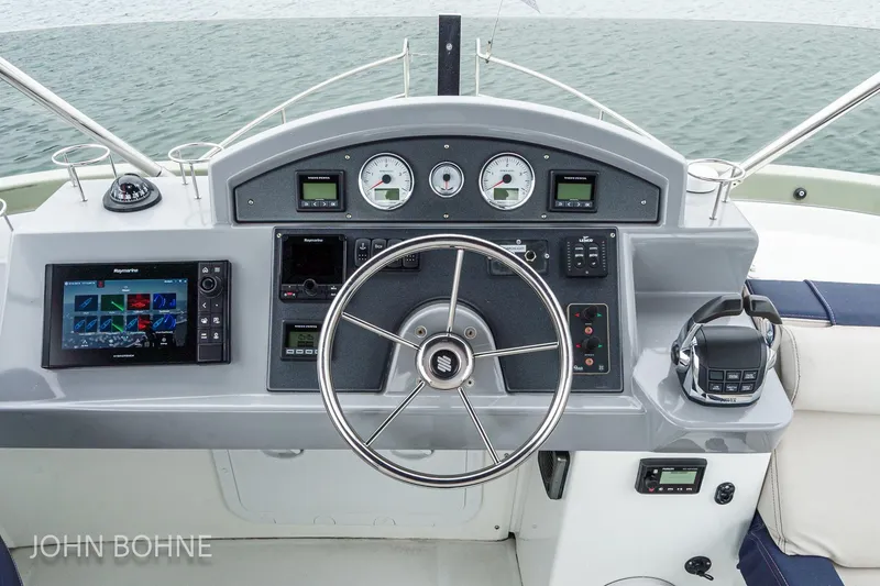 Slide: The Image of Helm of 2018 Beneteau Swift Trawler 44 with modern navigation equipment and steering wheel. - 24