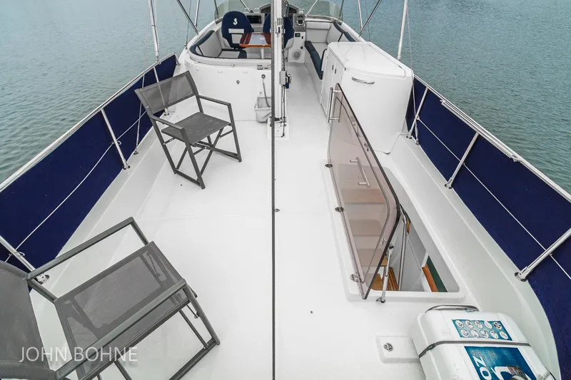 Slide: The Image of 2018 Beneteau Swift Trawler 44 deck with chairs and railing, overlooking water. - 33