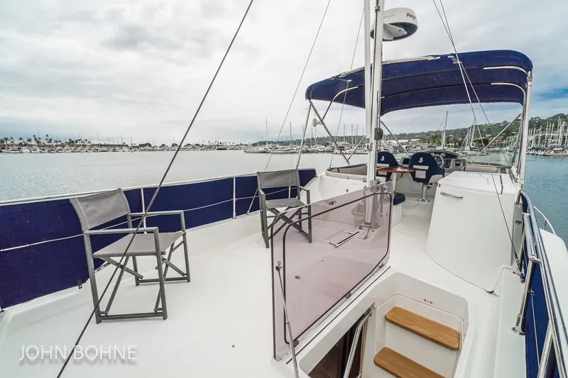 Slide: The Image of 2018 Beneteau Swift Trawler 44, spacious deck with seating, docked in a marina. - 34