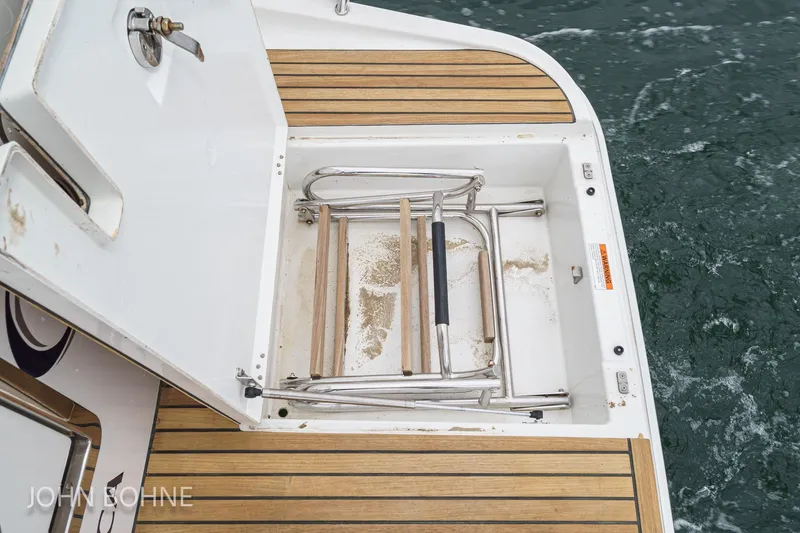 Slide: The Image of 2018 Beneteau Swift Trawler 44 swim platform with folding ladder and teak decking. - 37