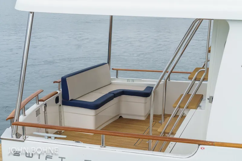 Slide: The Image of 2018 Beneteau Swift Trawler 44, rear deck seating area with ocean view. - 40
