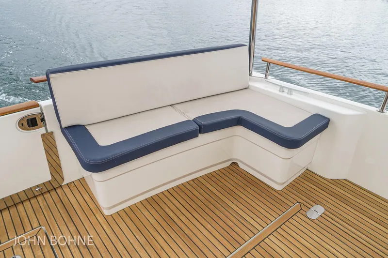Slide: The Image of Beneteau Swift Trawler 44, 2018 model, featuring elegant deck seating with blue cushions. - 41