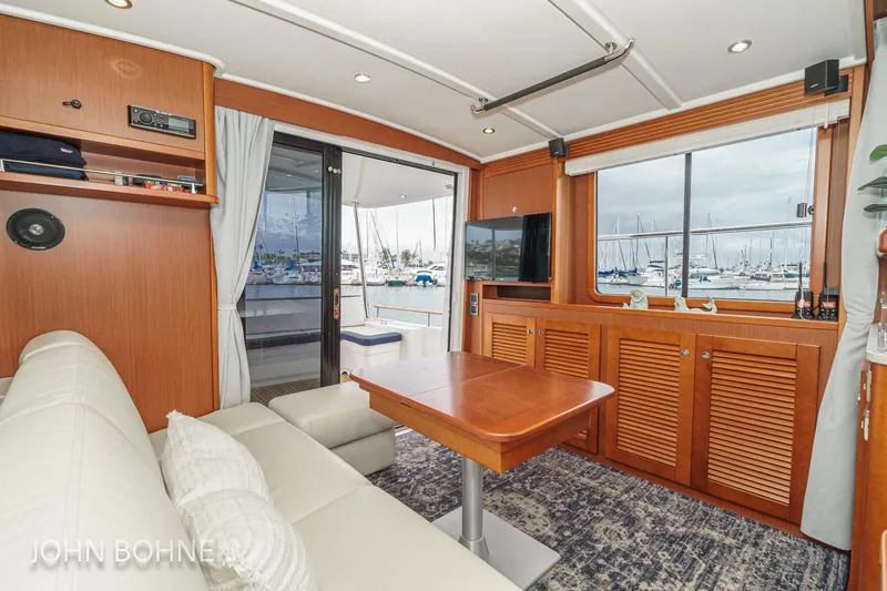 Slide: The Image of Interior of 2018 Beneteau Swift Trawler 44 with marina view through windows. - 51