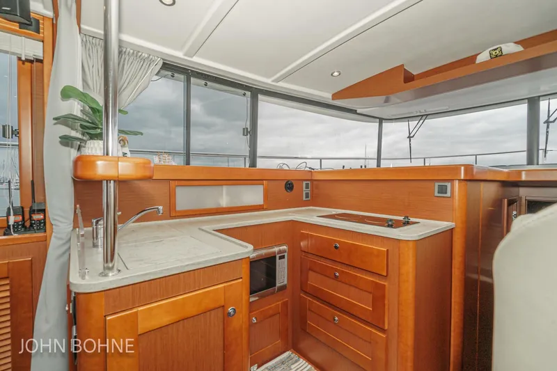 Slide: The Image of Interior of 2018 Beneteau Swift Trawler 44 with modern kitchen and wood finish. - 59