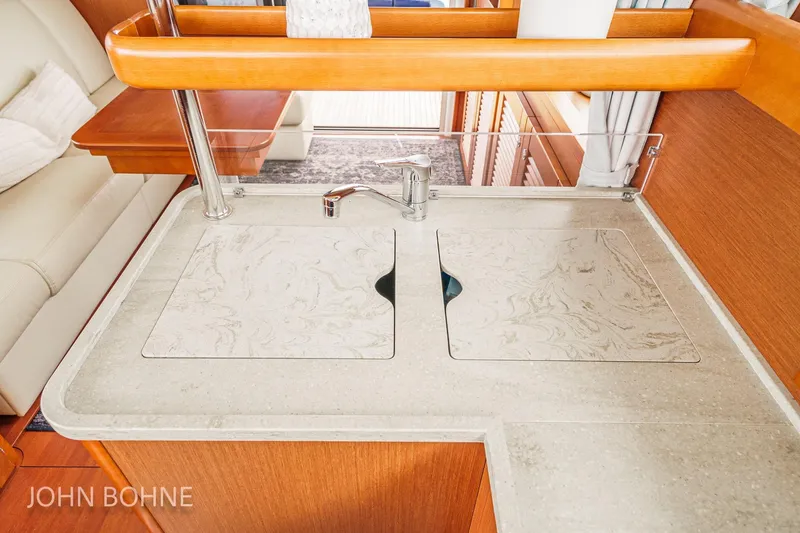 Slide: The Image of 2018 Beneteau Swift Trawler 44 interior kitchen with modern sink and countertop design. - 62