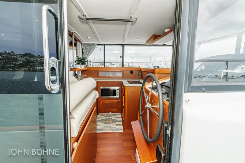 Slide: The Image of Interior view of 2018 Beneteau Swift Trawler 44, featuring helm and modern amenities. - 70