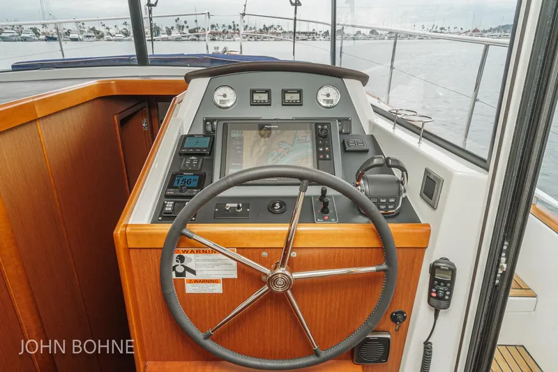 Slide: The Image of Helm of 2018 Beneteau Swift Trawler 44 with navigation equipment and steering wheel. - 72