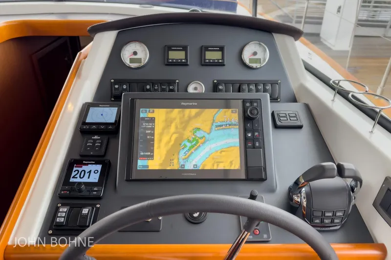 Slide: The Image of Control panel of 2018 Beneteau Swift Trawler 44 with navigation display and instruments. - 73