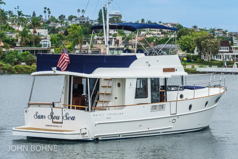 Slide: The Image of 2018 Beneteau Swift Trawler 44 on water, Newport Beach, American flag displayed. - 8