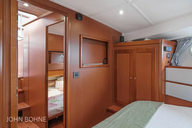 Slide: The Image of Interior of 2018 Beneteau Swift Trawler 44, featuring wood paneling and cozy cabin space. - 82