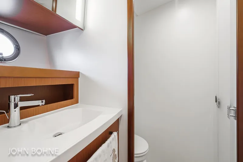 Slide: The Image of 2018 Beneteau Swift Trawler 44 bathroom with modern sink and wooden accents. - 84