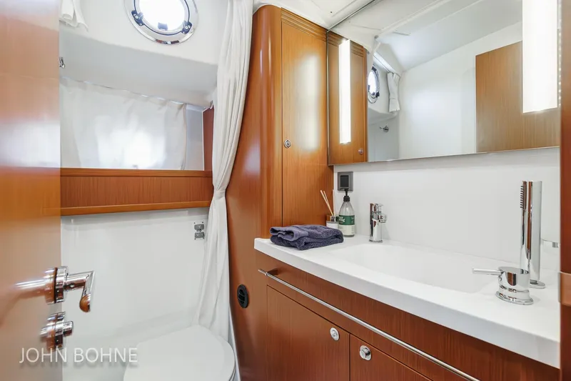 Slide: The Image of Luxurious bathroom in 2018 Beneteau Swift Trawler 44 with modern fixtures and wood accents. - 88