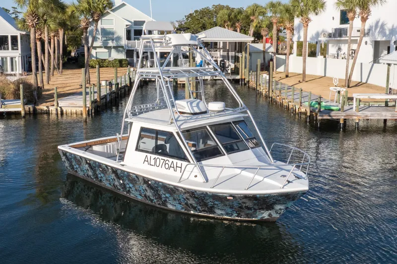Slide: The Image of 2000 Island Hopper 30 boat docked, featuring a sleek design and vibrant exterior. - 12