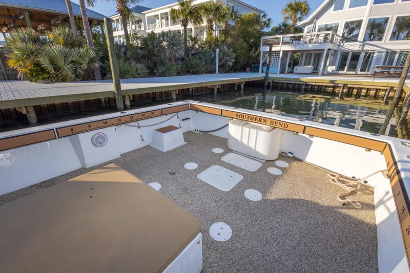 Slide: The Image of Island Hopper 30 boat deck, 2000 model, docked near waterfront homes. - 19