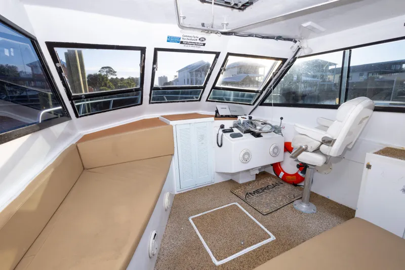 Slide: The Image of Interior of 2000 Island Hopper 30 boat with helm, seating, and windows. - 20