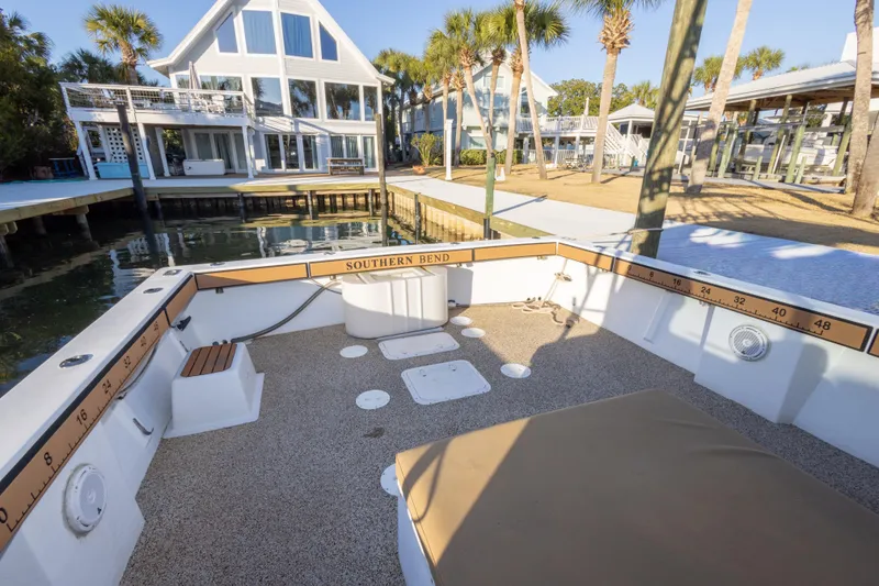 Slide: The Image of Island Hopper 30 boat docked near waterfront homes, surrounded by palm trees. - 21