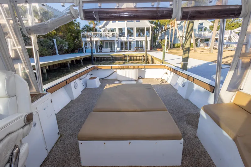 Slide: The Image of Interior view of 2000 Island Hopper 30 boat with seating and waterfront backdrop. - 22