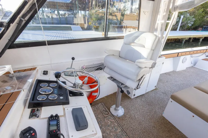 Slide: The Image of Helm of 2000 Island Hopper 30 boat with steering wheel and captain's chair. - 24