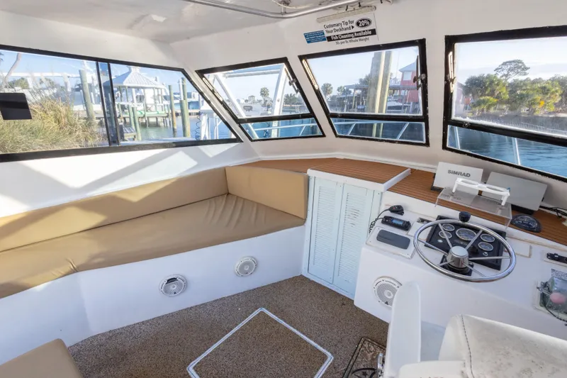 Slide: The Image of Interior of 2000 Island Hopper 30 boat with helm and seating area. - 25
