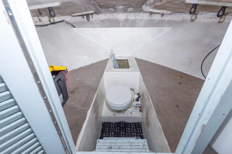 Slide: The Image of Interior of 2000 Island Hopper 30 boat with toilet and storage area. - 26