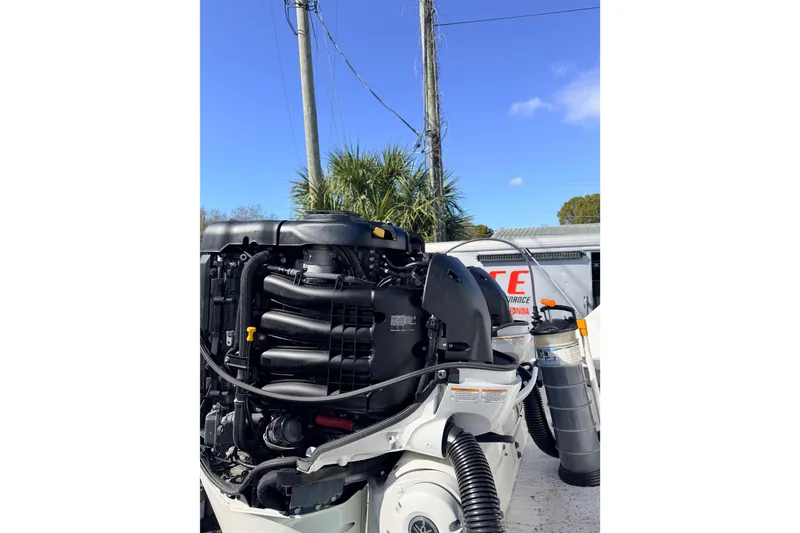 Slide: The Image of Outboard engine of a 2020 Everglades 335 Center Console boat under a clear blue sky. - 10