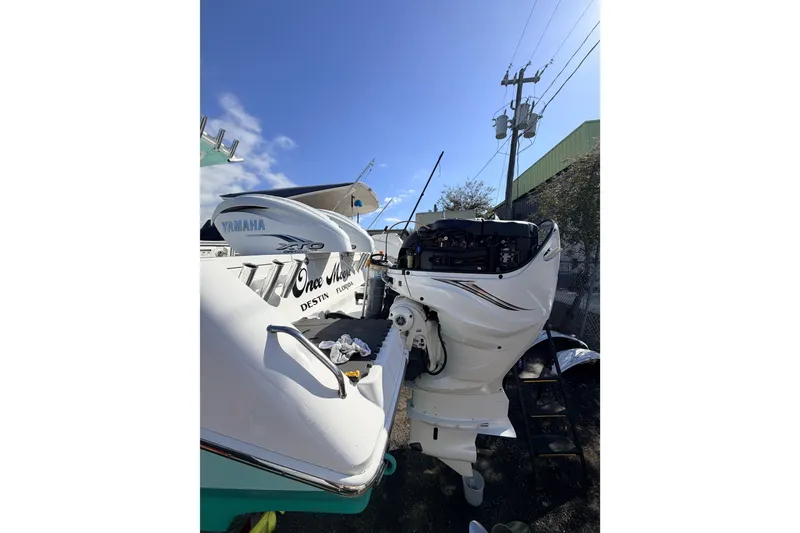 Slide: The Image of 2020 Everglades 335 Center Console with Yamaha outboard engines, parked outdoors. - 12