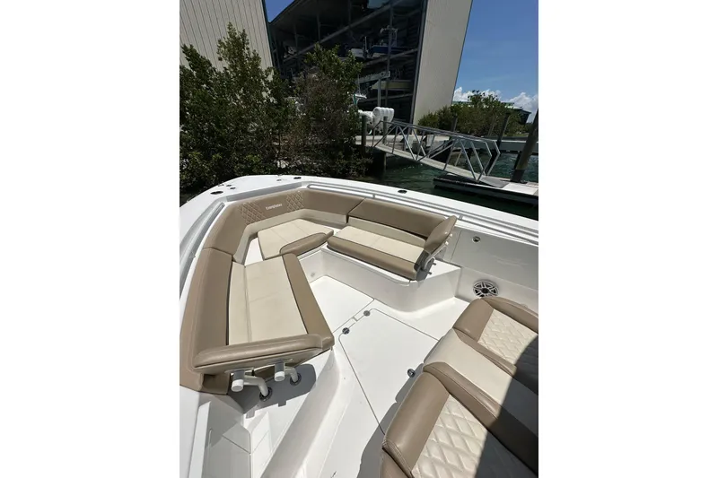 Slide: The Image of 2020 Everglades 335 Center Console boat with beige seating and spacious deck. - 17