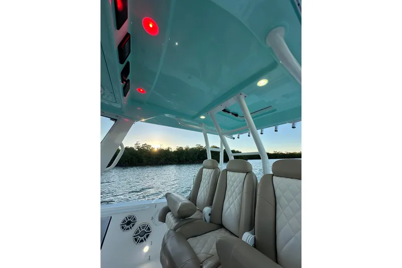 Slide: The Image of Interior view of 2020 Everglades 335 Center Console boat with luxurious seating and scenic water backdrop. - 19