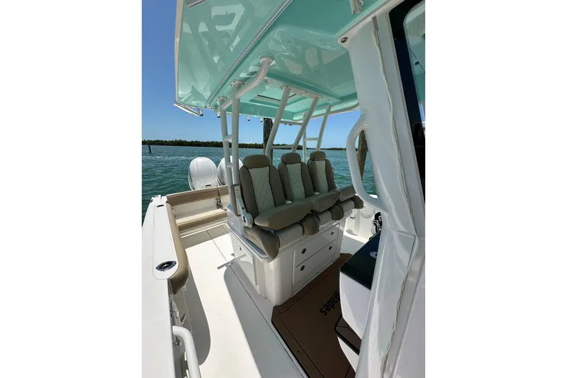 Slide: The Image of 2020 Everglades 335 Center Console boat interior with cushioned seating and ocean view. - 20