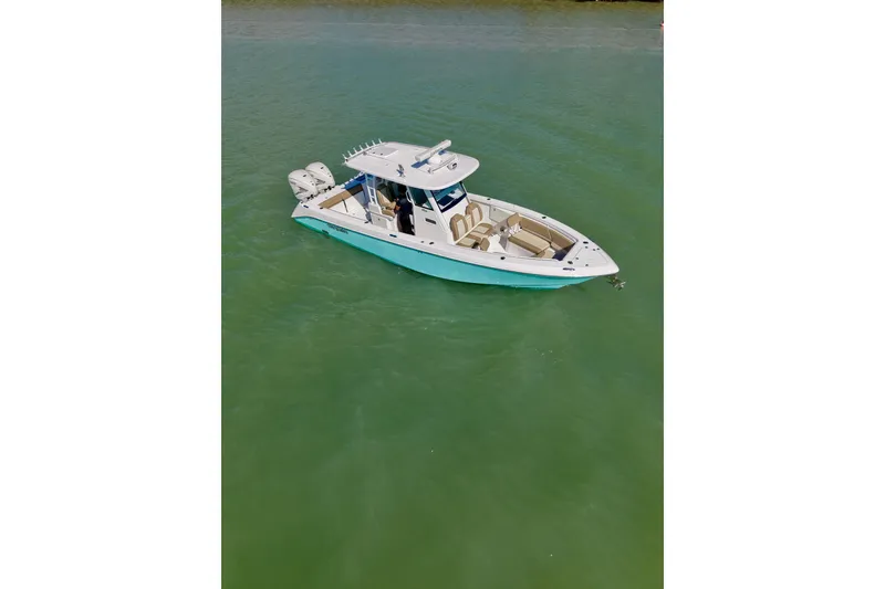 Slide: The Image of 2020 Everglades 335 Center Console boat on calm green water. - 3