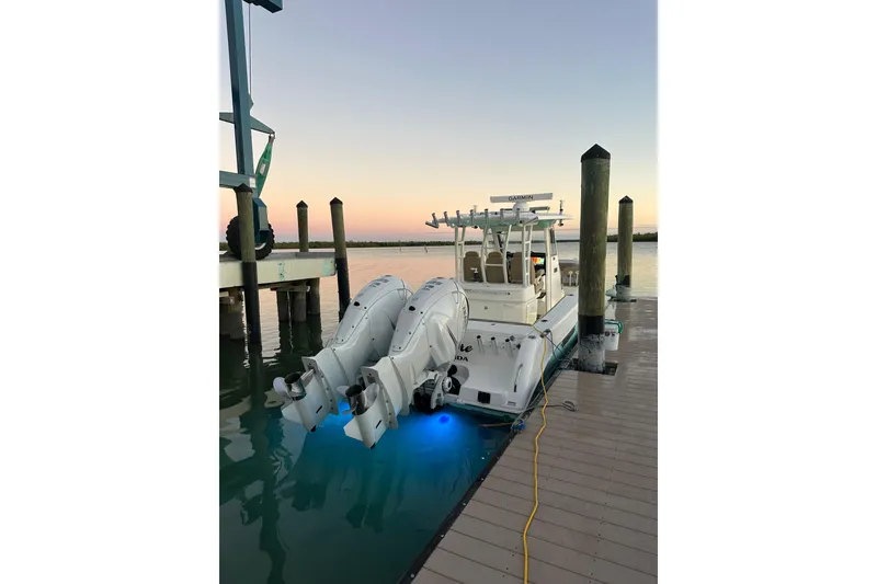 Slide: The Image of 2020 Everglades 335 Center Console boat docked at sunset with dual engines. - 6