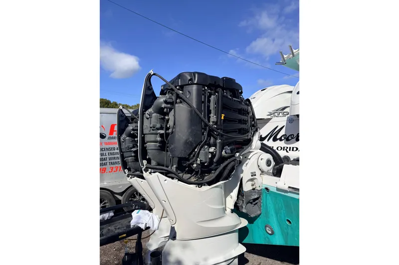 Slide: The Image of 2020 Everglades 335 Center Console boat engine, detailed view under blue sky. - 9