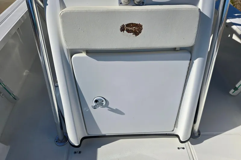 Slide: The Image of 2004 Triton 240 LTS boat console with storage compartment and padded seat. - 18