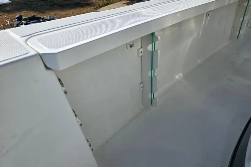 Slide: The Image of Interior view of a 2004 Triton 240 LTS boat, showcasing clean white surfaces. - 20