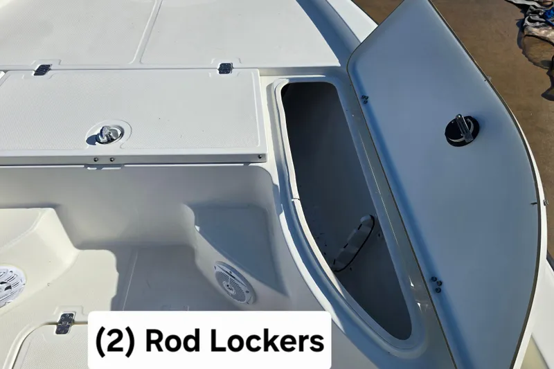 Slide: The Image of 2004 Triton 240 LTS boat with two open rod lockers. - 21