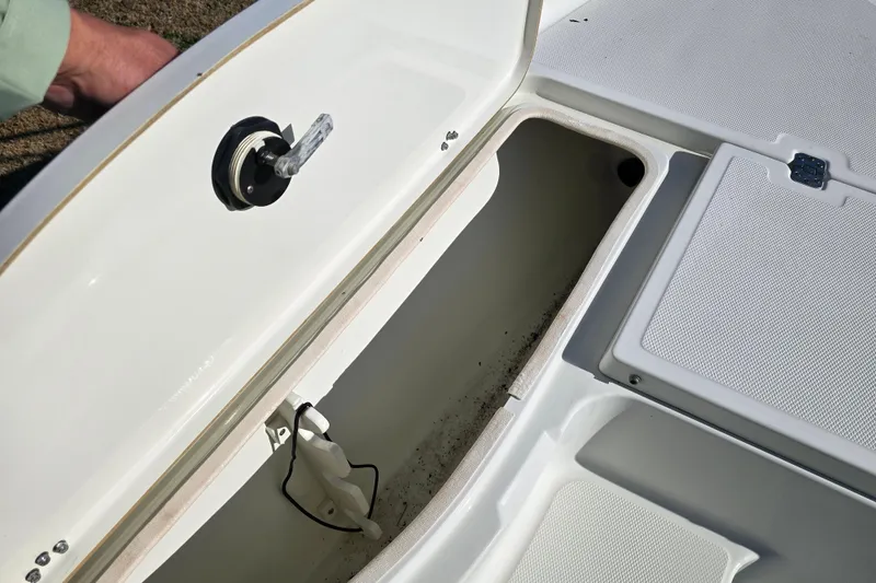 Slide: The Image of Open storage compartment on 2004 Triton 240 LTS boat, showing interior details. - 22