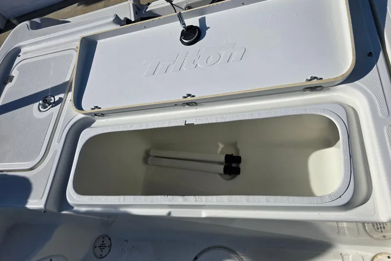 Slide: The Image of Open storage compartment on a 2004 Triton 240 LTS boat deck. - 23