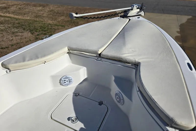 Slide: The Image of 2004 Triton 240 LTS boat bow with cushioned seating and storage compartments. - 30