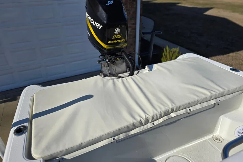 Slide: The Image of 2004 Triton 240 LTS boat with Mercury 225 engine, featuring cushioned seating area. - 31