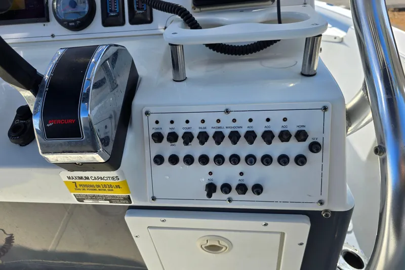 Slide: The Image of Control panel of a 2004 Triton 240 LTS boat with Mercury throttle. - 35