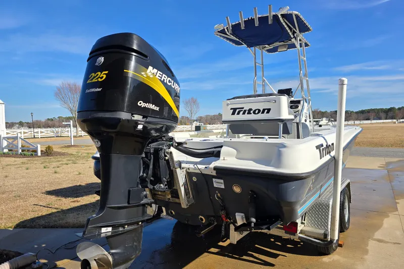 Slide: The Image of 2004 Triton 240 LTS boat with Mercury 225 OptiMax engine on a trailer. - 4