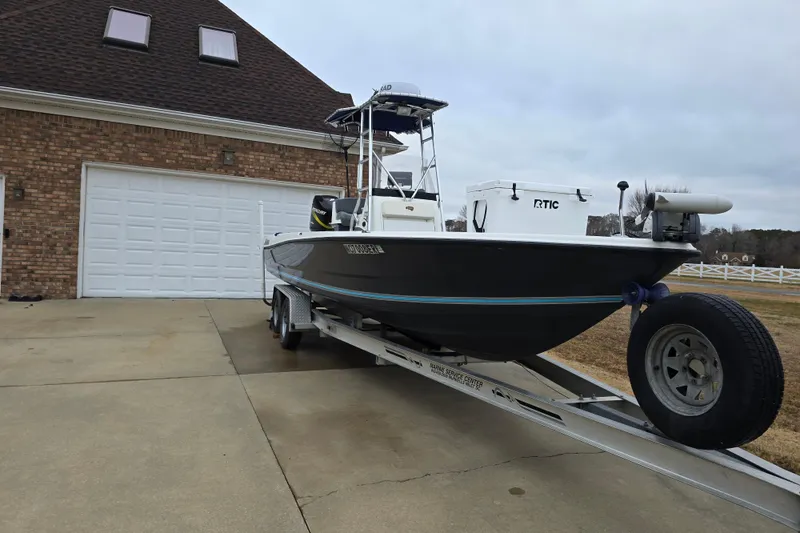 Slide: The Image of 2004 Triton 240 LTS boat on trailer in driveway, ready for transport. - 5