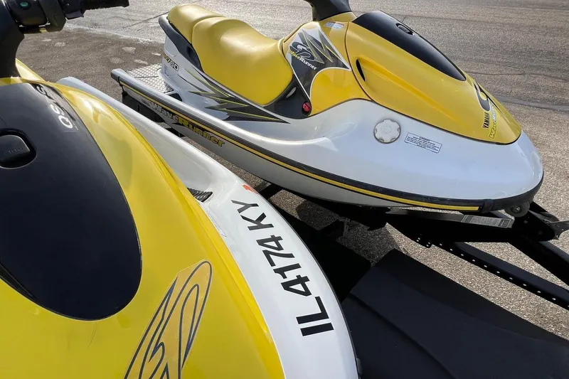 Slide: The Image of 1998 Yamaha GP760 jet ski with yellow and white design on a trailer. - 10