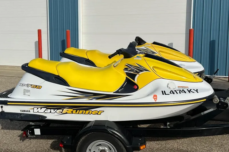 Slide: The Image of 1998 Yamaha GP760 WaveRunner jet skis with yellow seats on a trailer. - 11