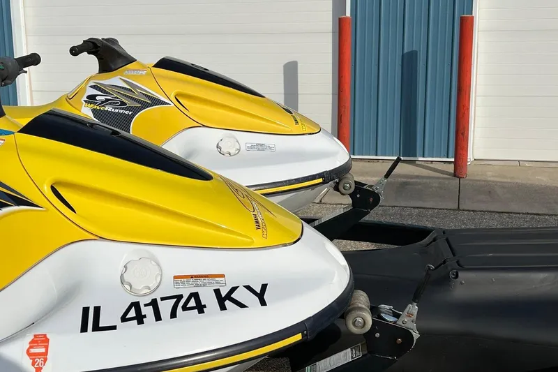 Slide: The Image of 1998 Yamaha GP760 jet skis in yellow and white, parked on a trailer. - 12