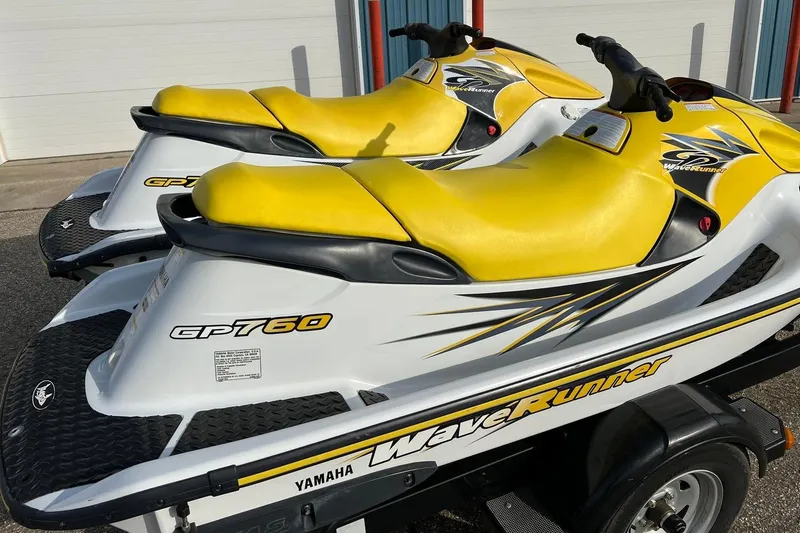 Slide: The Image of 1998 Yamaha GP760 WaveRunner with yellow seats and sleek design on a trailer. - 13