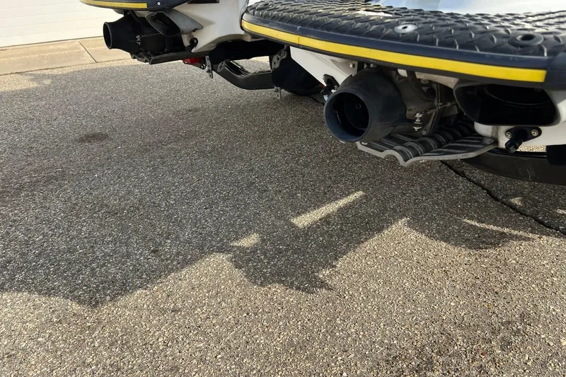 Slide: The Image of Rear view of a 1998 Yamaha GP760 jet ski on pavement, showcasing exhaust and footrests. - 14