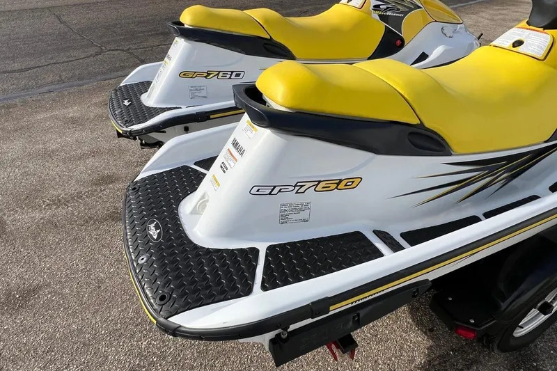 Slide: The Image of 1998 Yamaha GP760 jet skis with yellow seats on a trailer. - 7